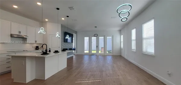 a kitchen with a sink stainless steel appliances and cabinets