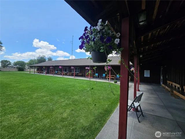 a view of a patio with table and chairs and potted plants