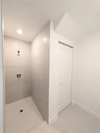 a bathroom with a shower and a sink