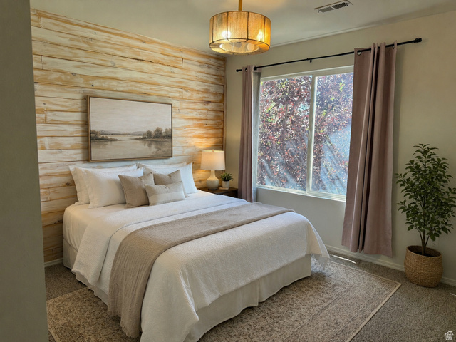 1038 West 950 South Springville, UT 84663 - Photo 13 of 14 Bedroom featuring a textured wood-plank accent wall, overhead drum light fixture, and a large window