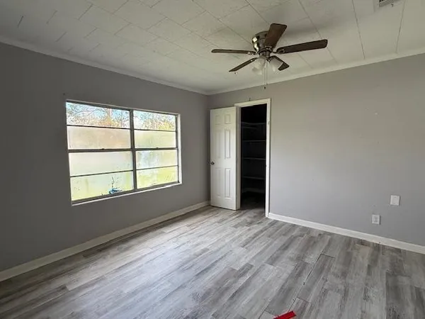 wooden floor in an empty room with a window