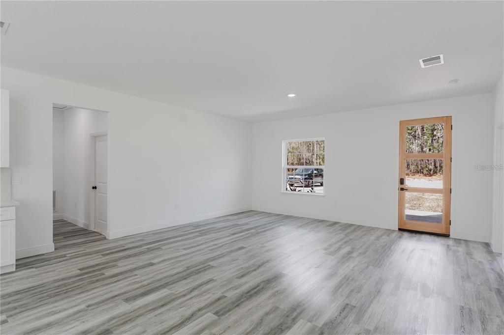 6732 Southwest 132nd Street Ocala, FL 34473 - Photo 15 of 36 an empty room with wooden floor and window