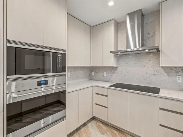 a kitchen with white cabinets and appliances