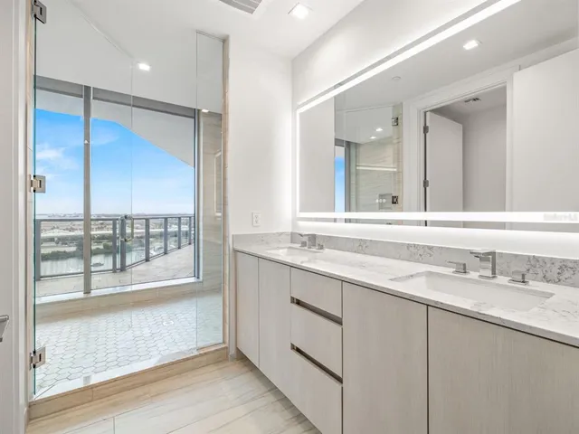 a bathroom with a double vanity sink and a mirror