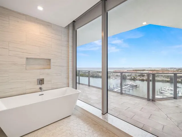 a bathroom with a bathtub and windows
