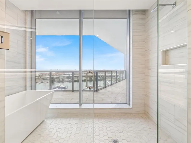 a bathroom with a bathtub and a shower