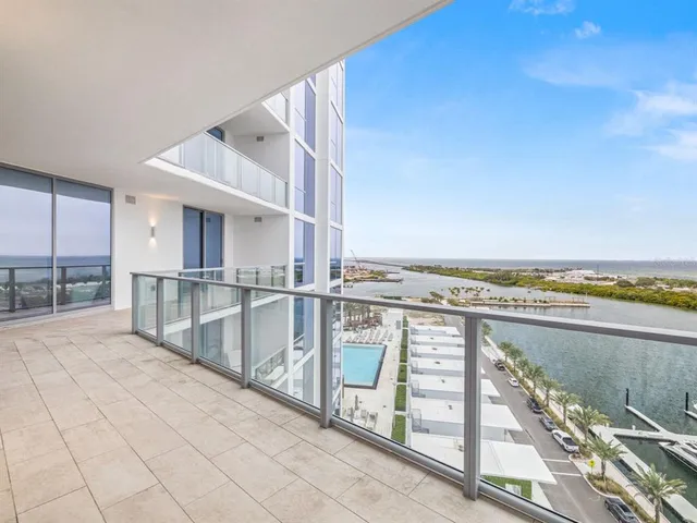a view of a kitchen with large windows