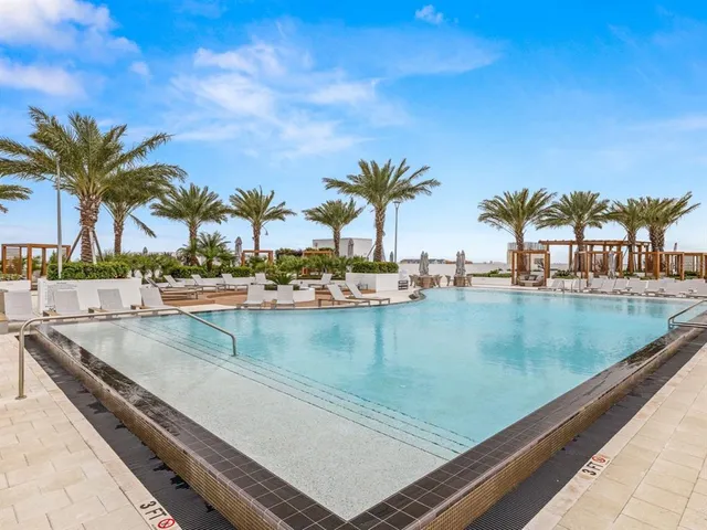 a view of swimming pool with outdoor seating and city view