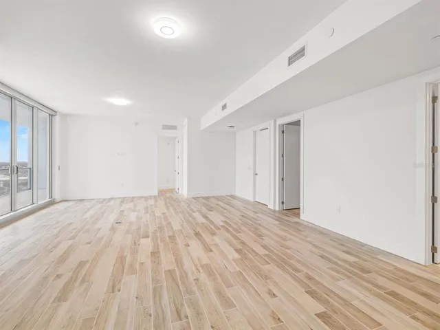 a view of an empty room and wooden floor