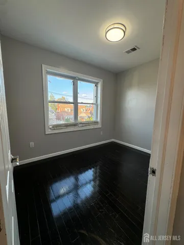a view of an empty room and wooden floor