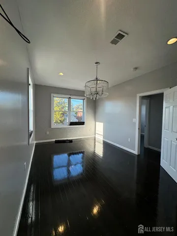 a large white room with a large mirror and sink