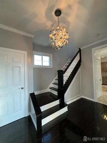 a view of entryway with wooden floor and chandelier