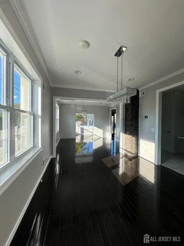a kitchen with kitchen island granite countertop a sink counter top space appliances and cabinets