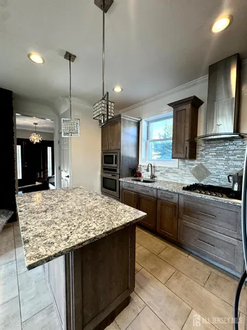 a kitchen with a stove sink and refrigerator