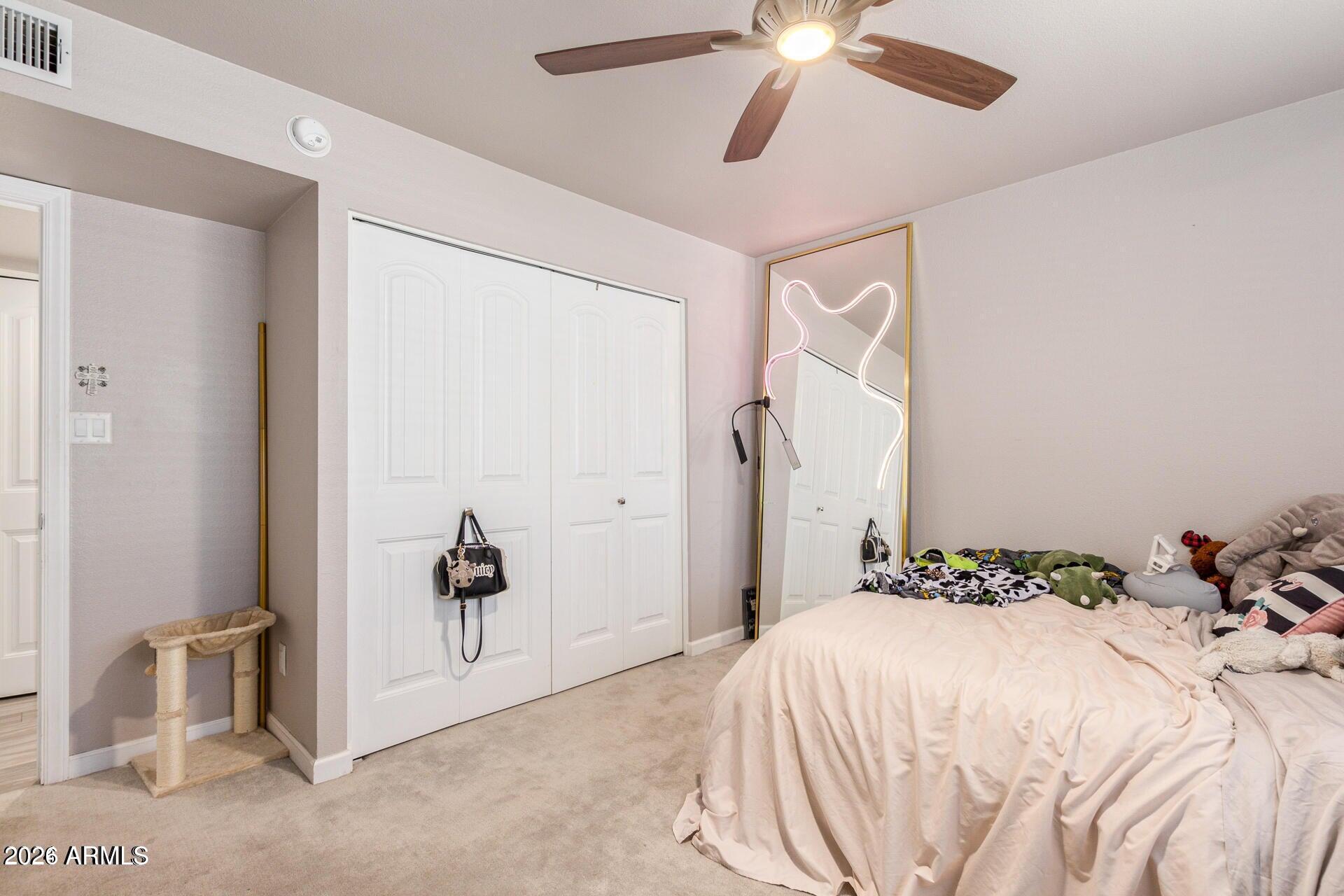 5913 East Thomas Road Scottsdale, AZ 85251 - Photo 22 of 26 a bedroom with a bed and a chandelier