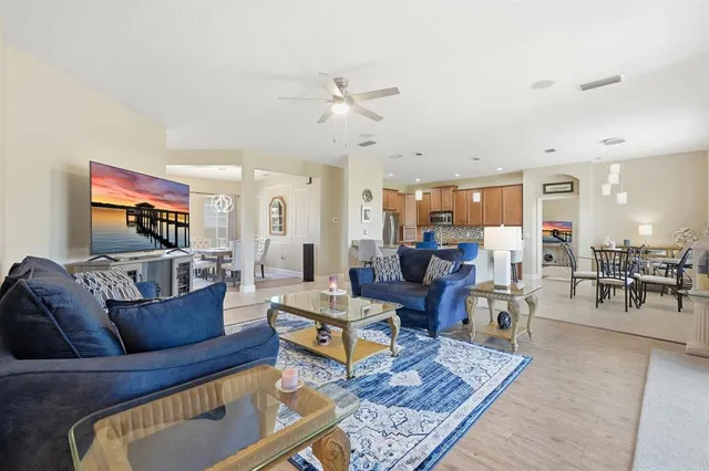 a living room with furniture potted plant and a view of kitchen