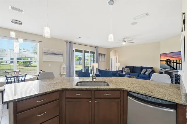 a kitchen with granite countertop a sink and a wooden cabinets