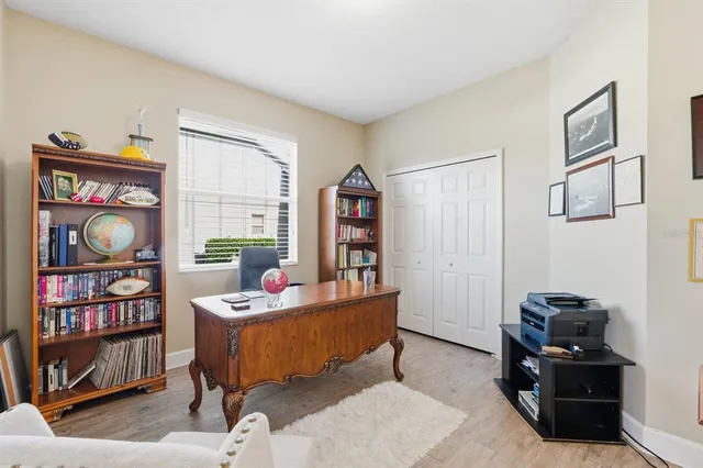 a living room with furniture a flat screen tv and a window