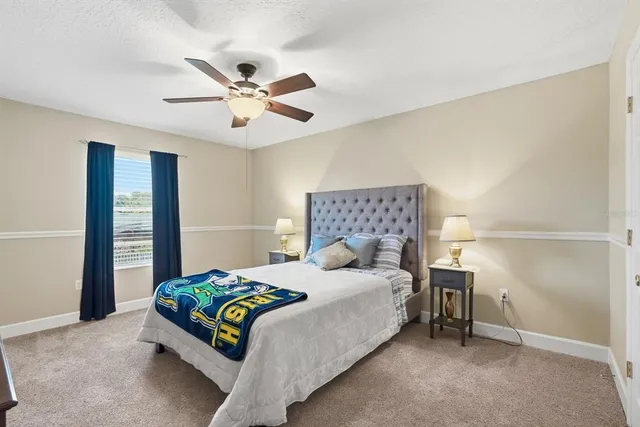 a bathroom with a sink a toilet and a large mirror