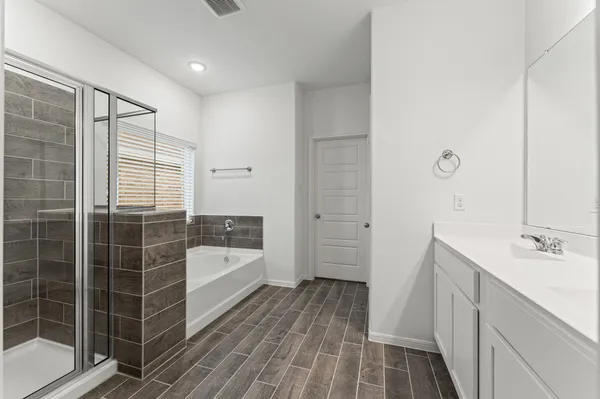 a bathroom with a tub sink and shower