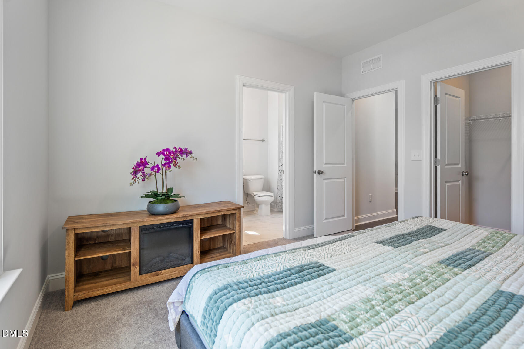 2966 Rise And Shine Road Apex, NC 27502 - Photo 39 of 61 a bedroom with a bed and a potted plant