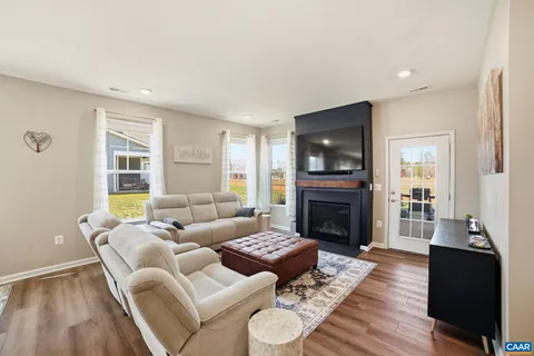 a living room with furniture fireplace and flat screen tv