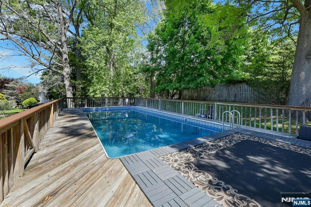 20 Blue Hill Road Norwood, NJ 07648 - Photo 46 of 49 a view of wooden deck and a yard with swimming pool