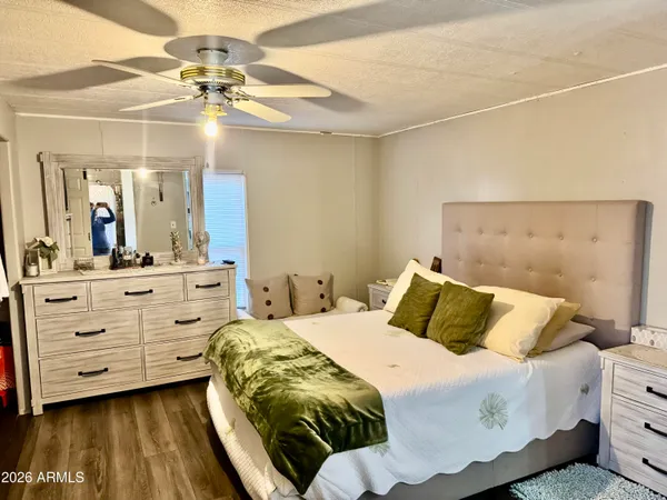 a bedroom with a bed and a chandelier