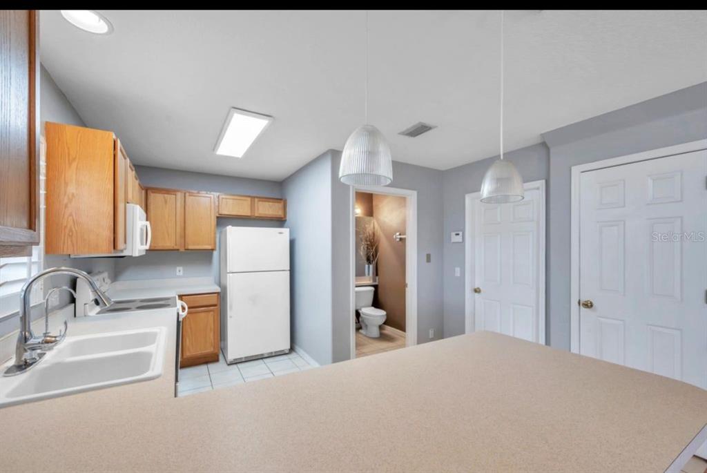 13059 Thoroughbred Loop Largo, FL 33773 - Photo 11 of 32 a bathroom with a sink and a mirror