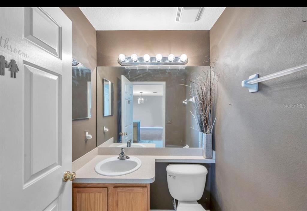 13059 Thoroughbred Loop Largo, FL 33773 - Photo 16 of 32 a bathroom with a sink and a mirror