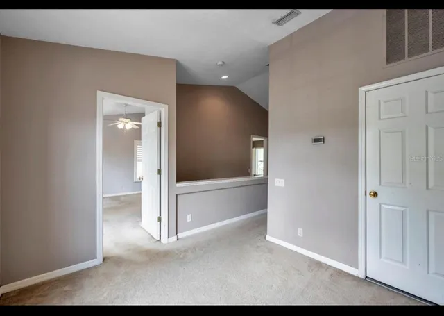 a view of a livingroom with wooden floor and cabinet