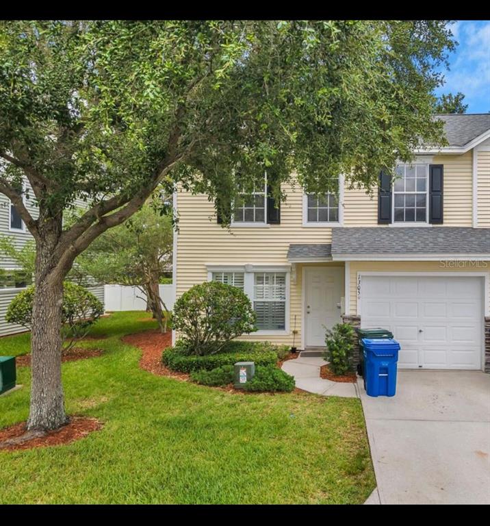 13059 Thoroughbred Loop Largo, FL 33773 - Photo 2 of 32 a view of a house with backyard and a tree