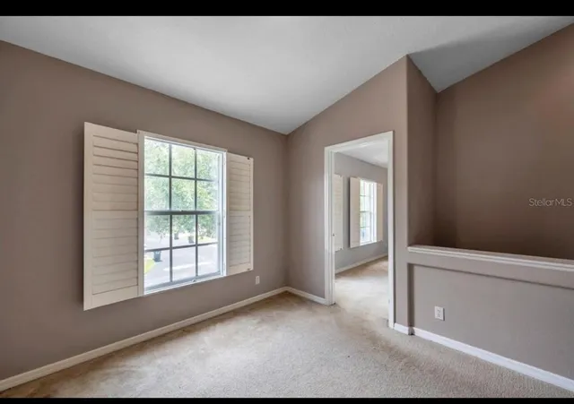 a view of an empty room with a window