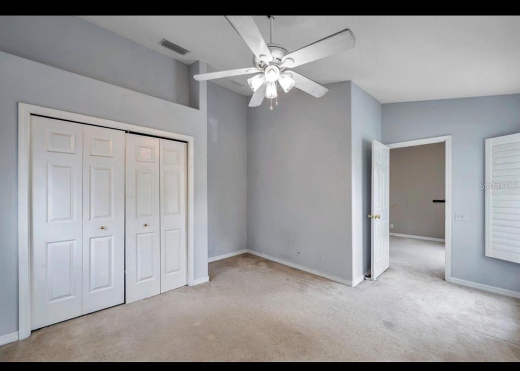 13059 Thoroughbred Loop Largo, FL 33773 - Photo 23 of 32 a view of an empty room and chandelier fan