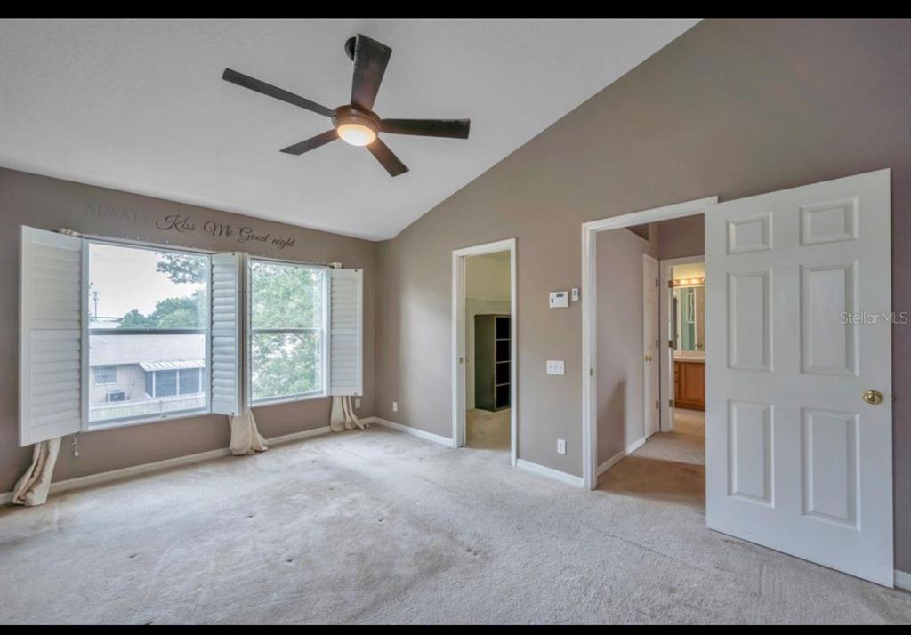 13059 Thoroughbred Loop Largo, FL 33773 - Photo 26 of 32 a view of a livingroom with a ceiling fan and window