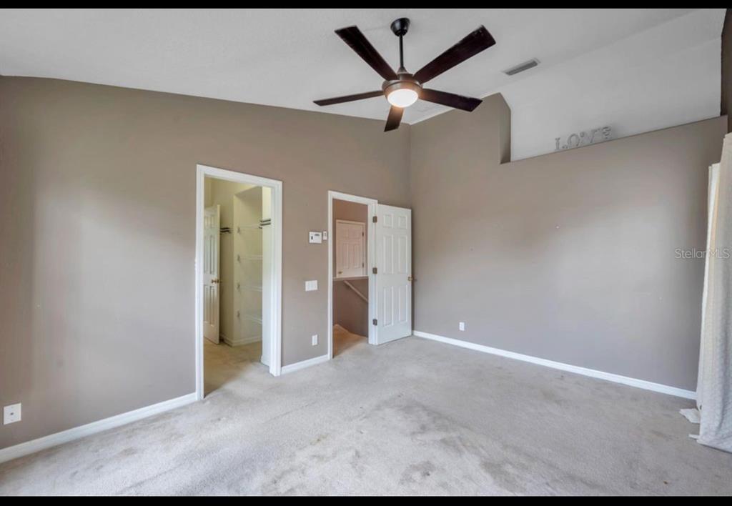 13059 Thoroughbred Loop Largo, FL 33773 - Photo 28 of 32 an empty room with closet and fan