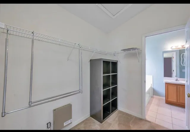 a view of walk in closet with empty racks