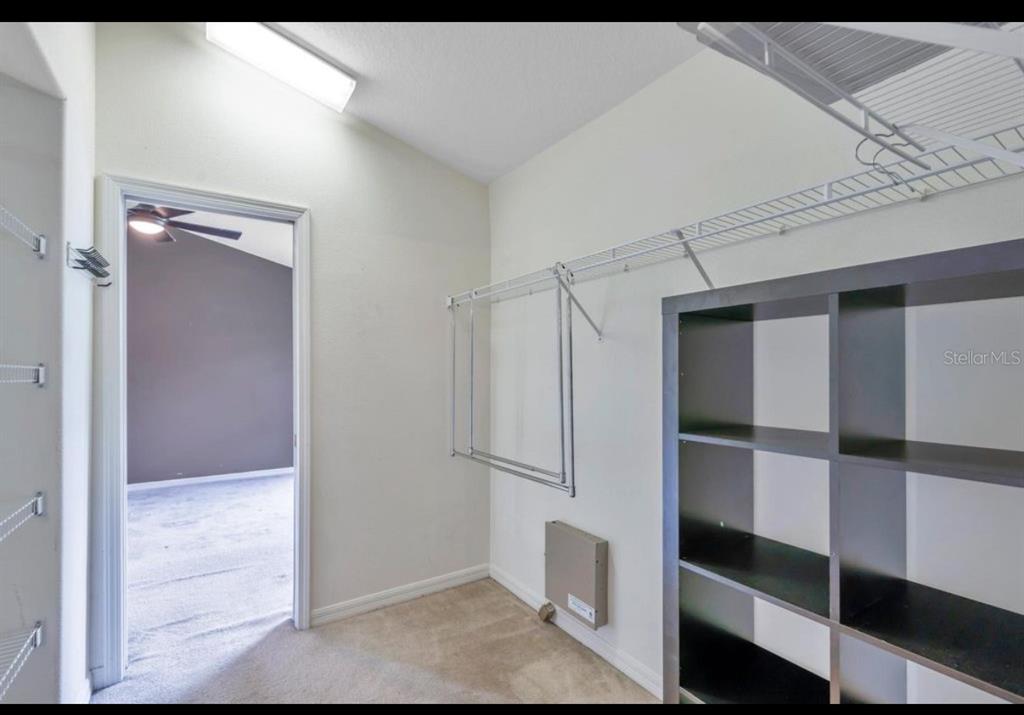 13059 Thoroughbred Loop Largo, FL 33773 - Photo 32 of 32 a view of walk in closet with empty racks