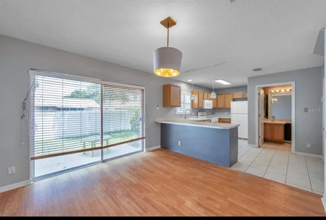 a kitchen with stainless steel appliances granite countertop a stove and a wooden cabinets