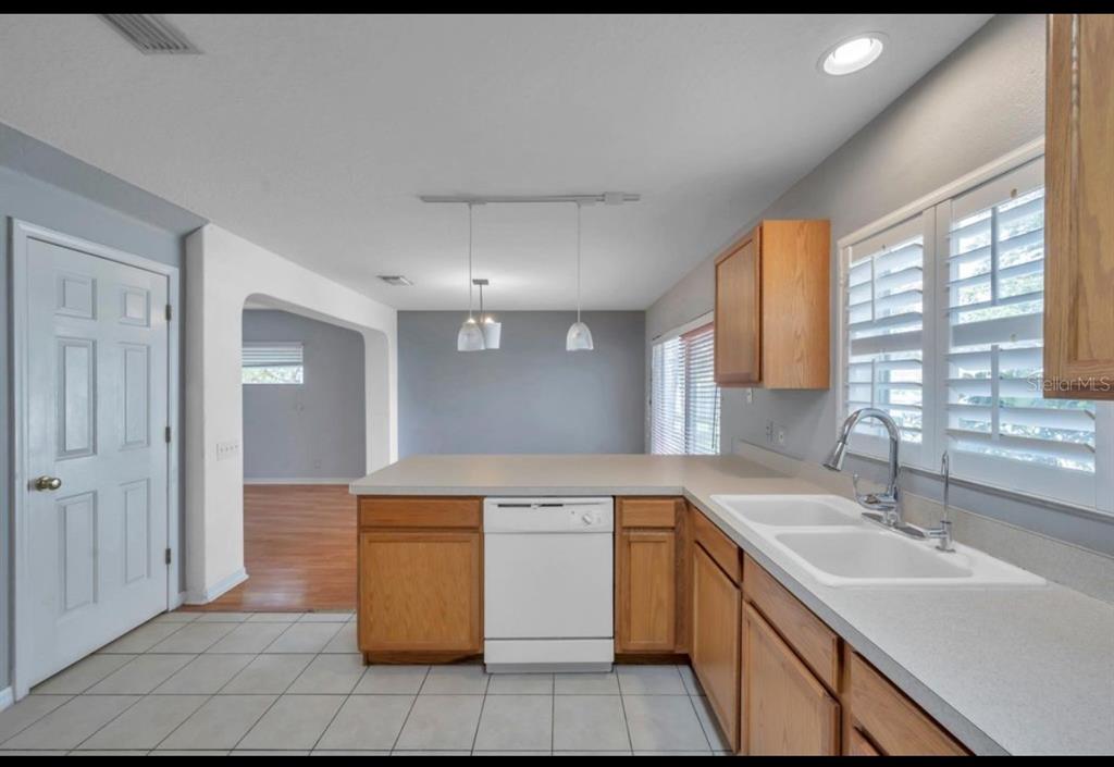 13059 Thoroughbred Loop Largo, FL 33773 - Photo 10 of 32 a kitchen with a sink stove and cabinets