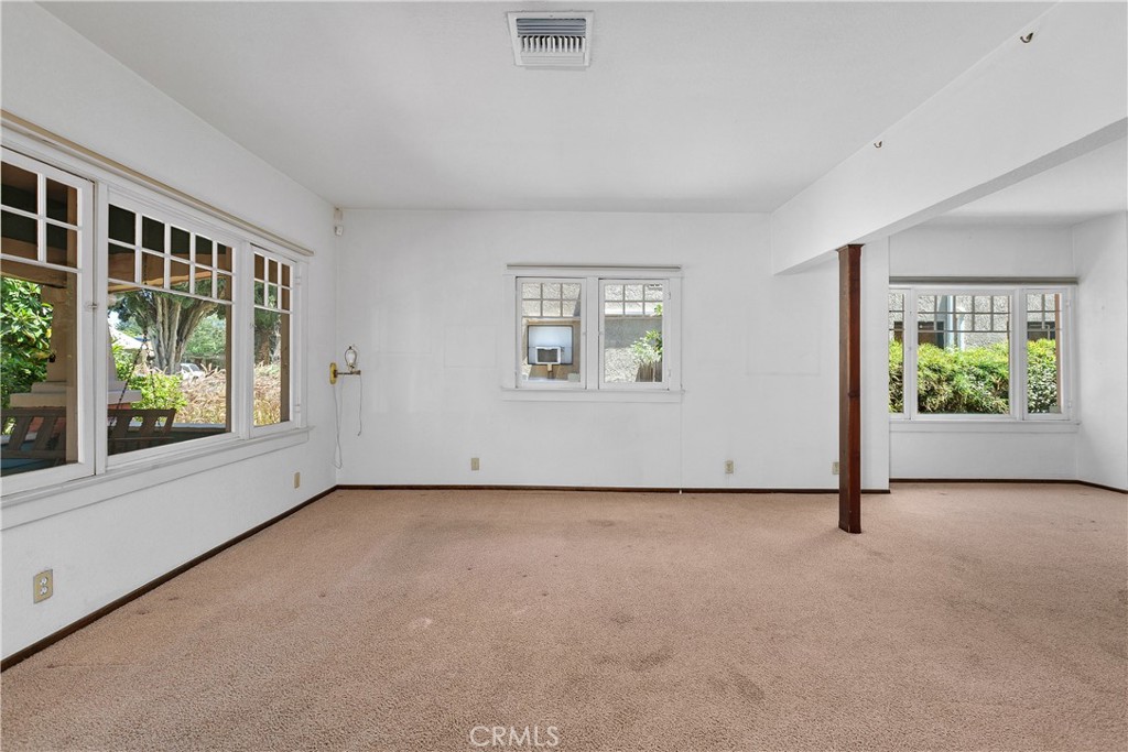3892 Oakwood Place Riverside, CA 92506 - Photo 7 of 36 This view shows the large windows providing views of the front porch and garden. It is the perfect spot for a sitting area to welcome guests.