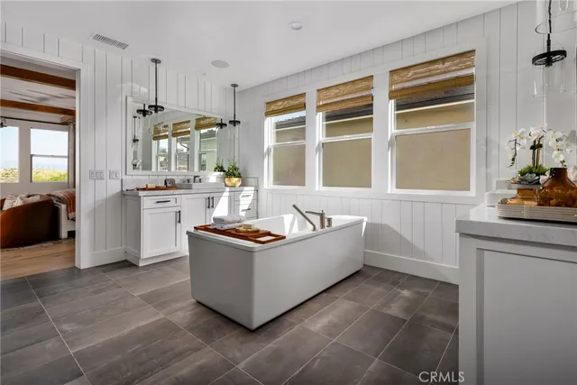 a living room with stainless steel appliances a stove a sink and a refrigerator