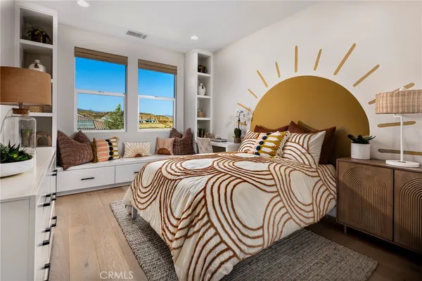 a bedroom with a bed and a large window