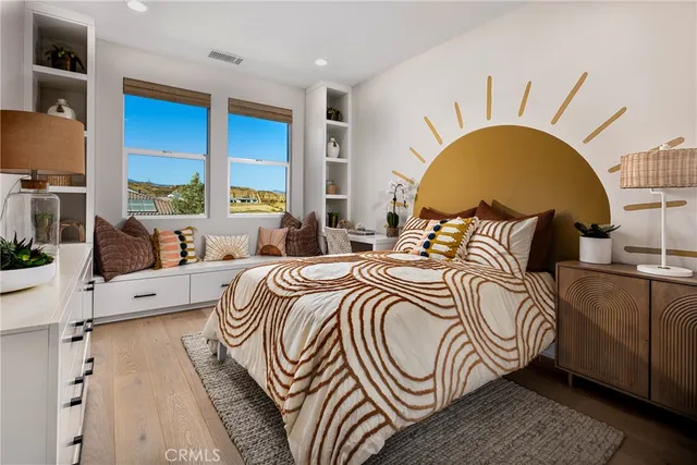 a bedroom with a bed and a large window