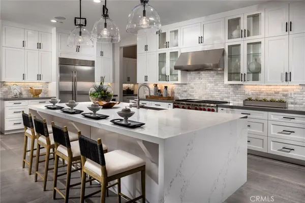 a kitchen with stainless steel appliances kitchen island granite countertop a sink and cabinets