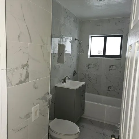 an empty room with windows and entrance