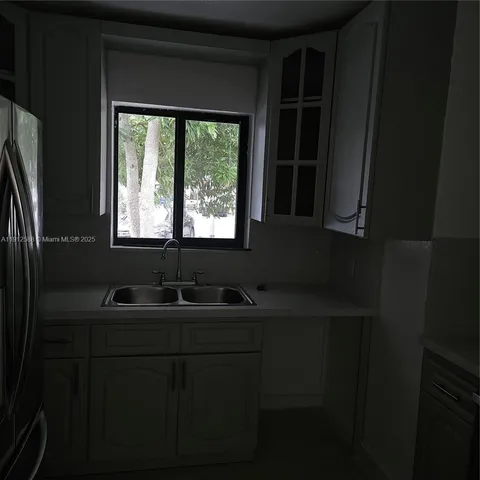 a bathroom with a sink a mirror and a window