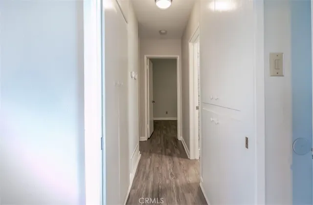 a view of a hallway with wooden floor