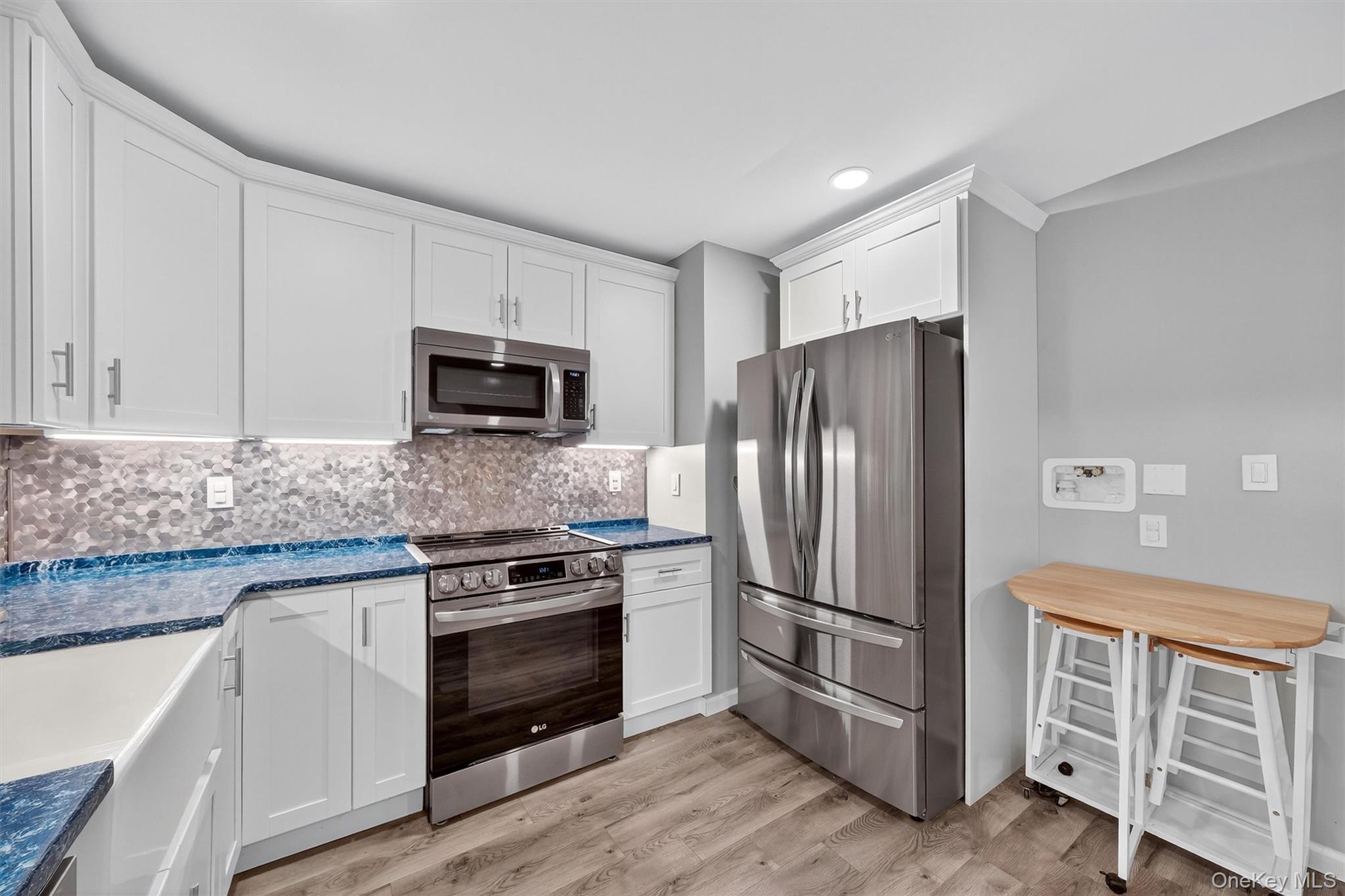 2710 South Road, Unit B5 Poughkeepsie, NY 12601 - Photo 12 of 19 a kitchen with granite countertop a refrigerator stove and microwave