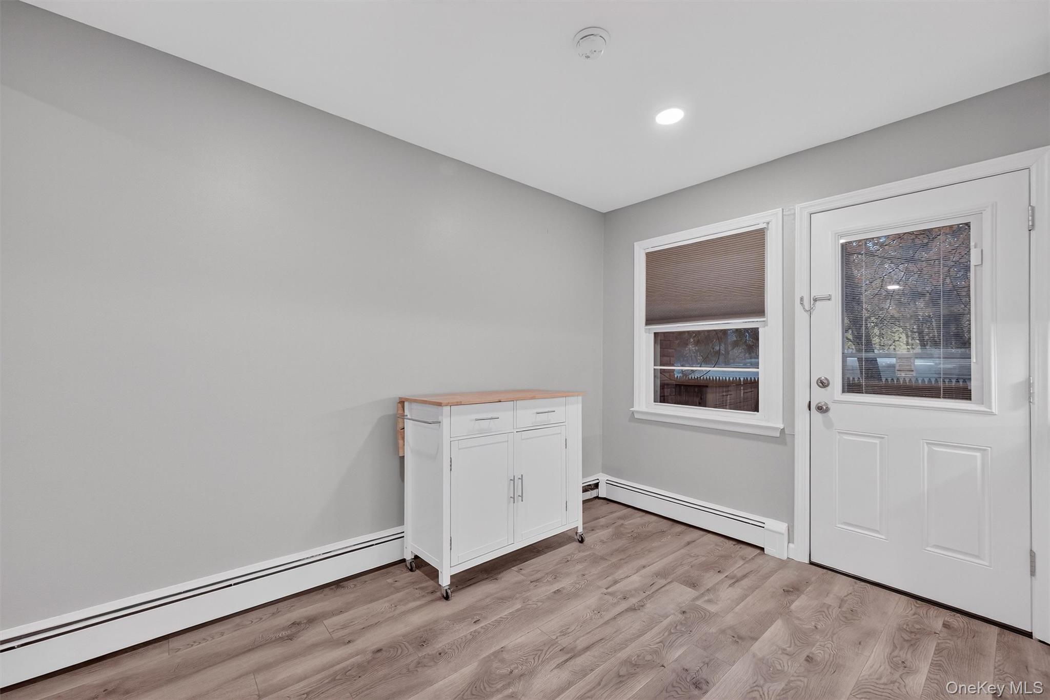 2710 South Road, Unit B5 Poughkeepsie, NY 12601 - Photo 13 of 19 an empty room with a wooden floor and windows